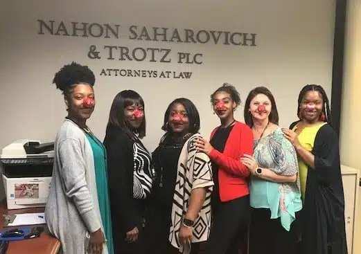 NST staff with red nose masks