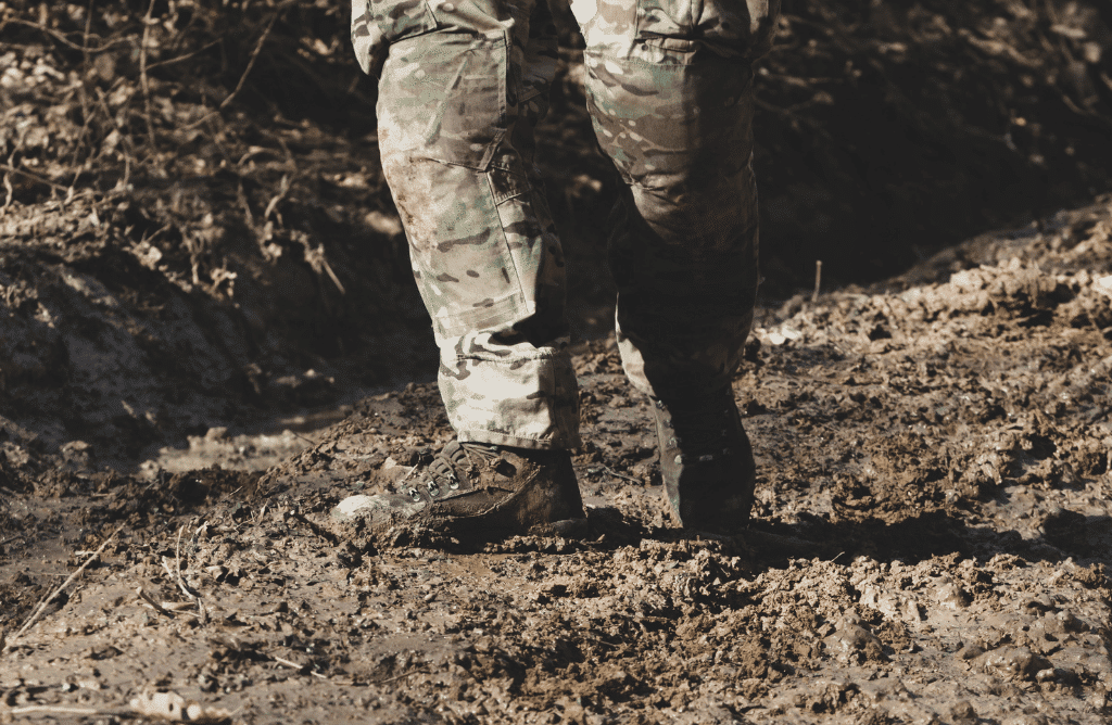 Solider standing on a dirt ground