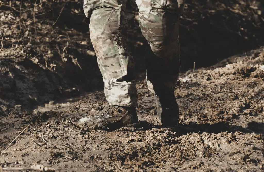 Solider standing on a dirt ground