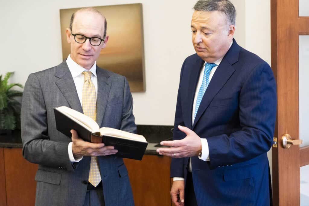 The lawyers of NST law going over a book