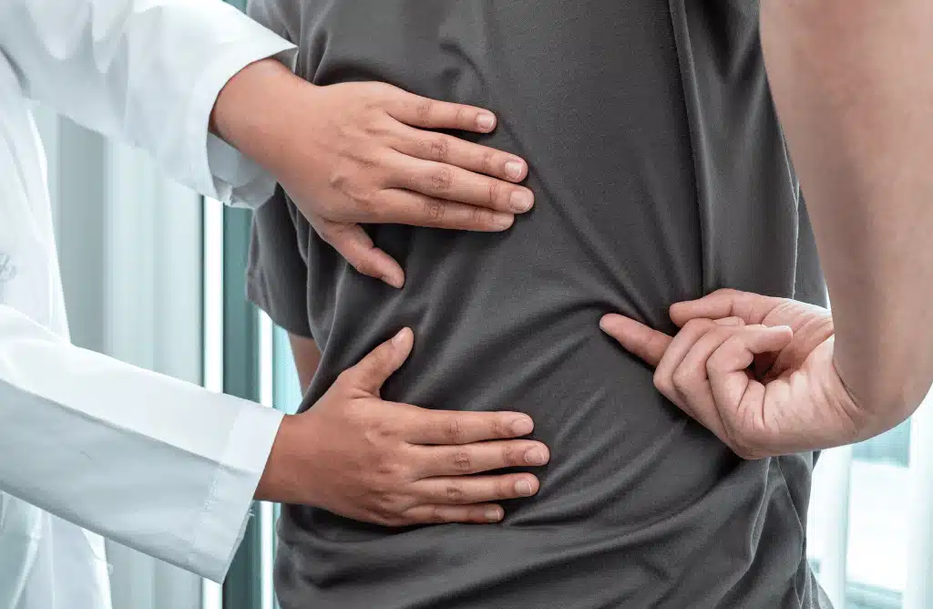 A patient pointing to his back pain