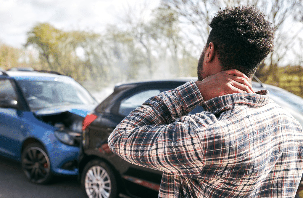 man holding his neck due to injury after car accident