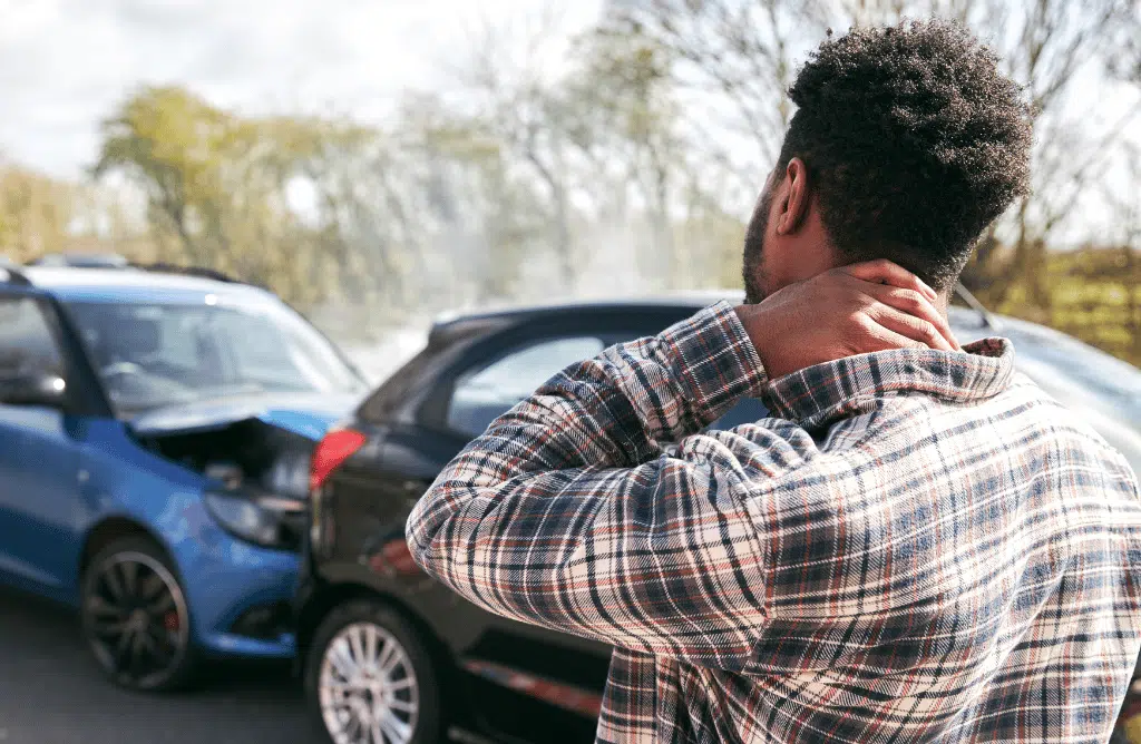 man holding his neck due to injury after car accident