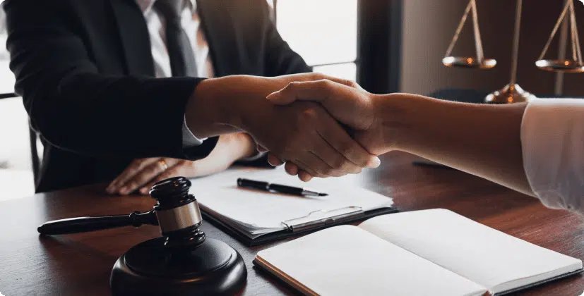 A lawyer and a client shaking hands