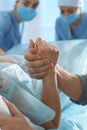 A person holding hands during surgery